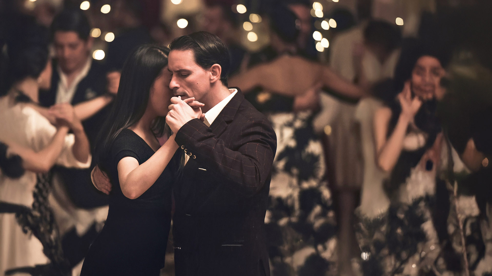 Smartly dressed, dancing couple.